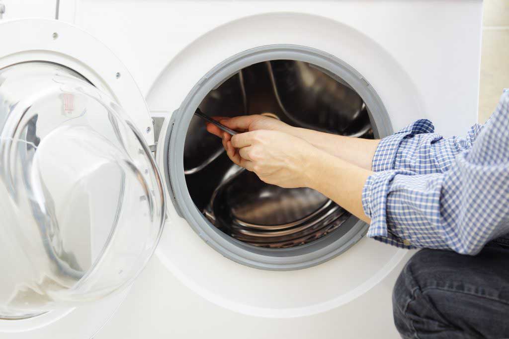 Appliance repair man repairing a dryer