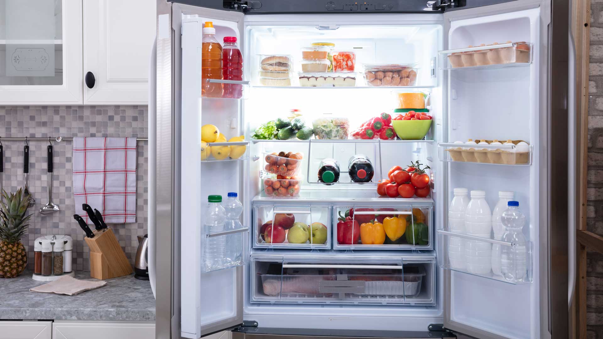 Fully-stocked refrigerator with doors opened